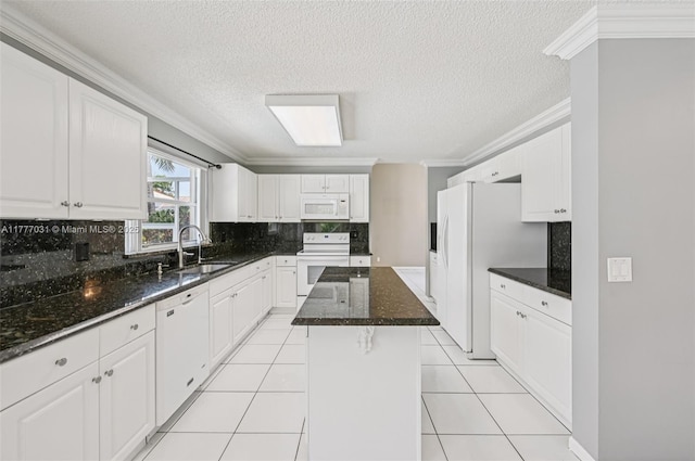 9145 Picot Ct, Boynton Beach, FL 33472 - kitchen featuring a sink, white appliances, crown molding, decorative backsplash, and white cabinetry