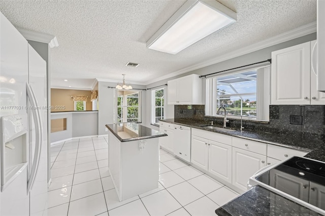 9145 Picot Ct, Boynton Beach, FL 33472 - kitchen with white appliances, a sink, a center island, ornamental molding, and a textured ceiling