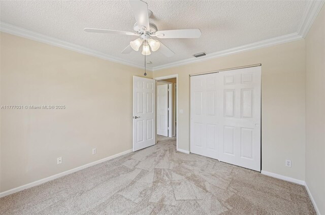 9145 Picot Ct, Boynton Beach, FL 33472 - unfurnished bedroom featuring carpet floors, a textured ceiling, a closet, baseboards, and crown molding
