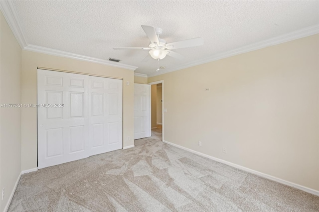 9145 Picot Ct, Boynton Beach, FL 33472 - unfurnished bedroom with a closet, ornamental molding, a textured ceiling, light colored carpet, and baseboards