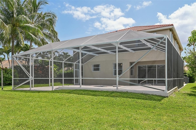 9145 Picot Ct, Boynton Beach, FL 33472 - rear view of house featuring a lanai, a patio, stucco siding, and a lawn