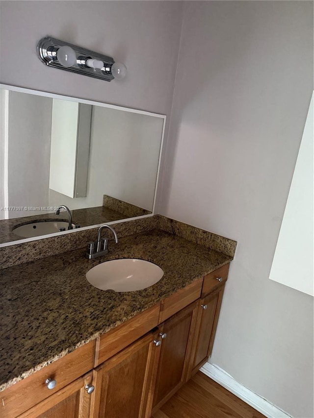 495 NW 72nd Ave Unit 305, Miami, FL 33126 - bathroom with vanity, wood finished floors, and baseboards