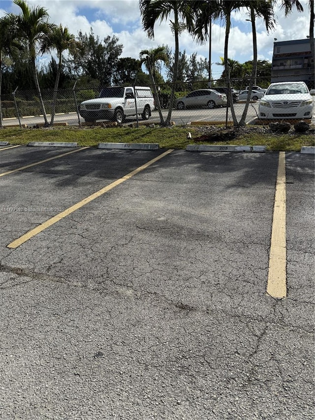 495 NW 72nd Ave Unit 305, Miami, FL 33126 - uncovered parking lot featuring fence