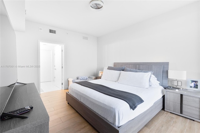 bedroom with visible vents and wood finished floors