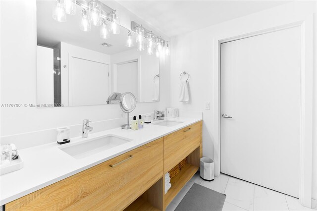 16385 Biscayne Blvd Unit 707, North Miami Beach, FL 33160 - bathroom featuring marble look tiles and double vanity