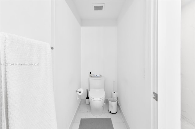 bathroom with visible vents, marble finish floor, baseboards, and toilet