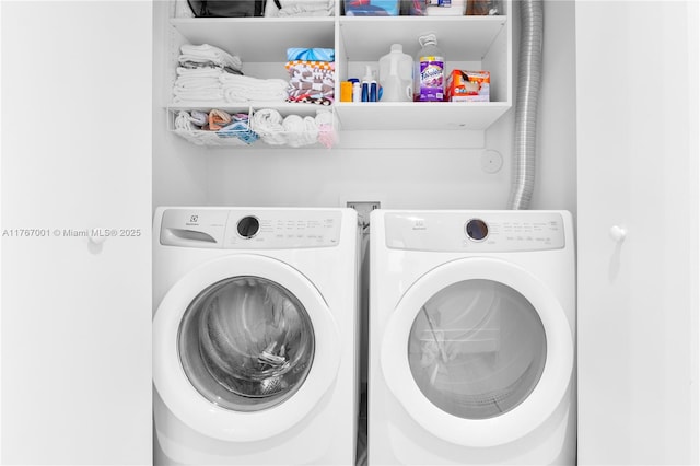 washroom with laundry area and washer and dryer