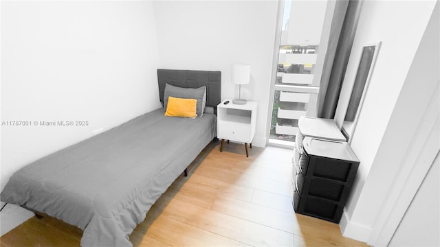 bedroom featuring light wood-style flooring