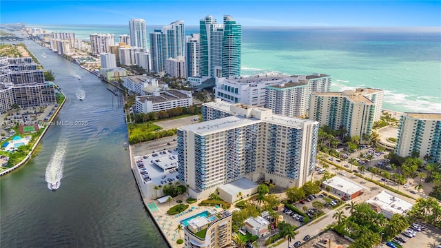 drone / aerial view featuring a view of city and a water view