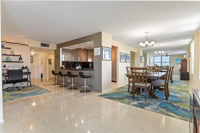 dining area with visible vents, baseboards, and a notable chandelier
