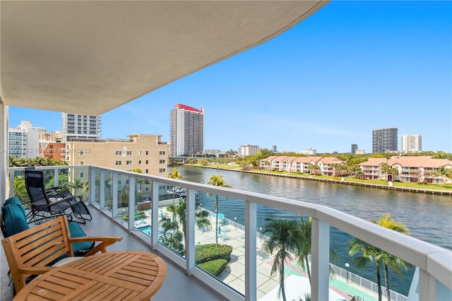balcony with a view of city and a water view