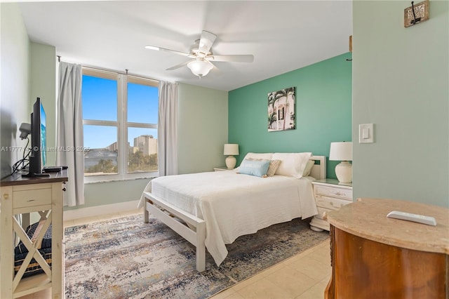tiled bedroom with a ceiling fan