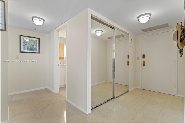 interior space featuring a sink, baseboards, and visible vents
