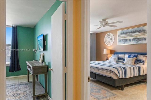 bedroom with a spacious closet, visible vents, and a ceiling fan