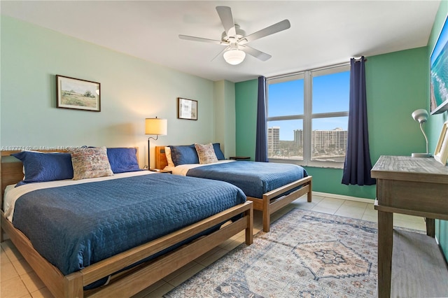bedroom featuring light tile patterned floors and a ceiling fan
