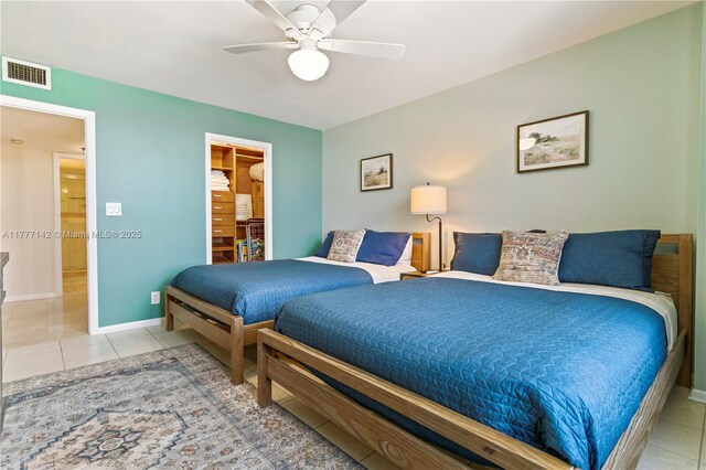 tiled bedroom with visible vents, baseboards, and ceiling fan