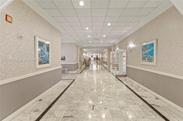 hallway with wallpapered walls, recessed lighting, french doors, crown molding, and a wainscoted wall