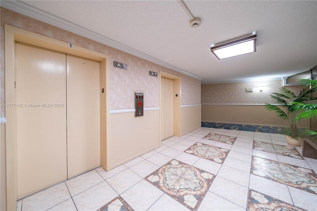 hall featuring elevator, wallpapered walls, crown molding, and a textured ceiling