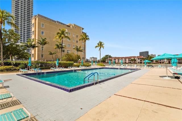 pool with a patio and fence