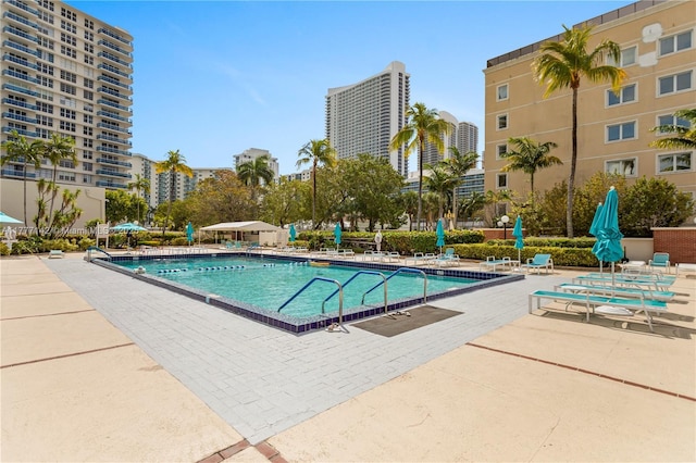 community pool featuring a patio and a city view