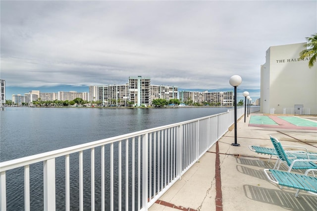 view of patio with a view of city, shuffleboard, and area for grilling