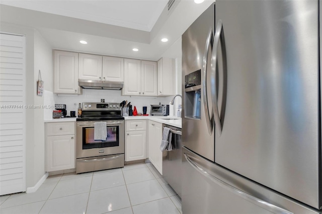 14773 Cumberland Dr Unit 208, Delray Beach, FL 33446 - kitchen featuring appliances with stainless steel finishes, recessed lighting, white cabinets, light countertops, and exhaust hood