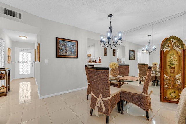 14773 Cumberland Dr Unit 208, Delray Beach, FL 33446 - dining space featuring a chandelier, light tile patterned flooring, and baseboards