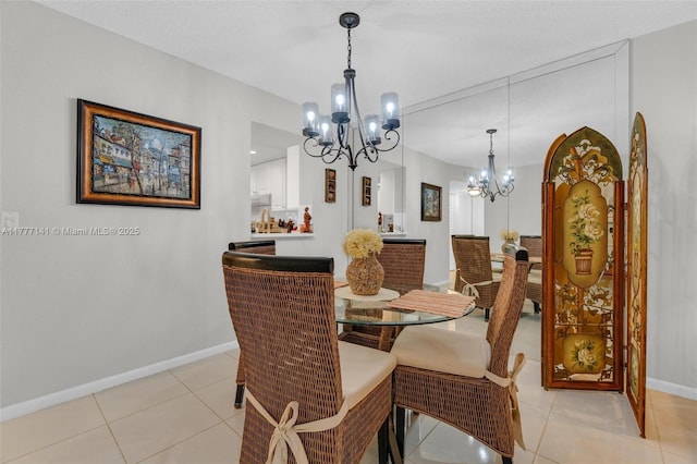 14773 Cumberland Dr Unit 208, Delray Beach, FL 33446 - dining area with a chandelier, baseboards, and light tile patterned floors