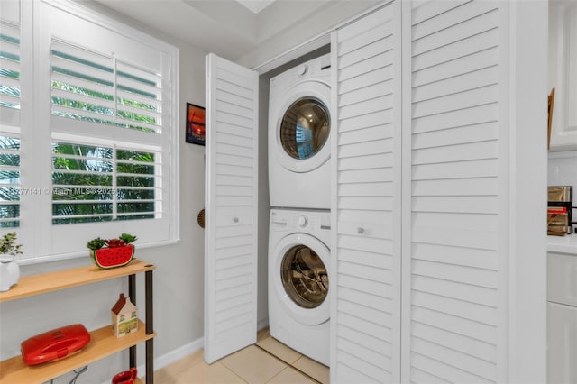 14773 Cumberland Dr Unit 208, Delray Beach, FL 33446 - washroom with estacked washer and dryer and light tile patterned flooring
