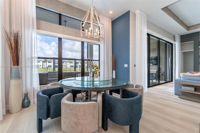 dining area with wood finished floors and a chandelier