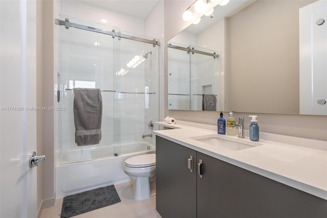 full bathroom featuring combined bath / shower with glass door, toilet, tile patterned floors, and vanity