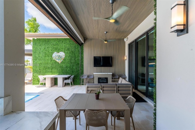 view of patio / terrace featuring outdoor dining space, an outdoor hangout area, and ceiling fan
