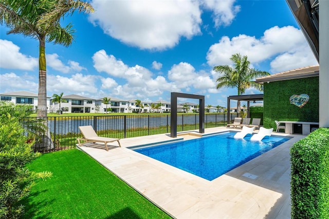 view of swimming pool featuring fence, a residential view, a fenced in pool, a yard, and a patio area