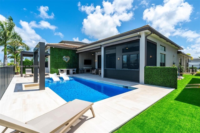 view of pool featuring a patio area, a fenced in pool, fence, a sunroom, and a yard