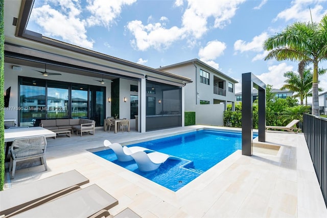 view of swimming pool with outdoor lounge area, a fenced in pool, a patio, and a ceiling fan