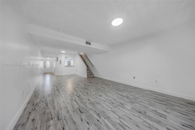 12302 NW 11th St Unit 1402, Miami, FL 33182 - unfurnished living room featuring wood finished floors, baseboards, visible vents, and stairs