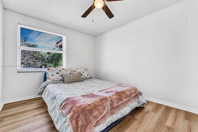 16226 Opal Creek Dr, Weston, FL 33331 - bedroom with a textured ceiling, baseboards, a ceiling fan, and wood finished floors