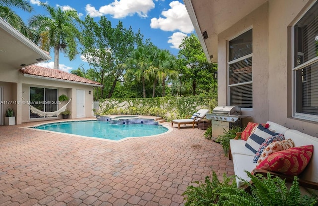 1604 Victoria Pointe Ln, Weston, FL 33327 - view of swimming pool featuring area for grilling, a patio, and a pool with connected hot tub