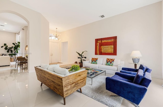 1604 Victoria Pointe Ln, Weston, FL 33327 - living area with arched walkways, light tile patterned floors, and a chandelier