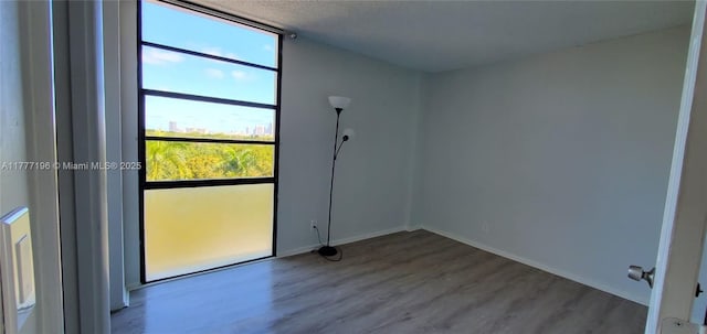 3301 N Country Club Dr Unit 612, Aventura, FL 33180 - unfurnished room with baseboards and wood finished floors