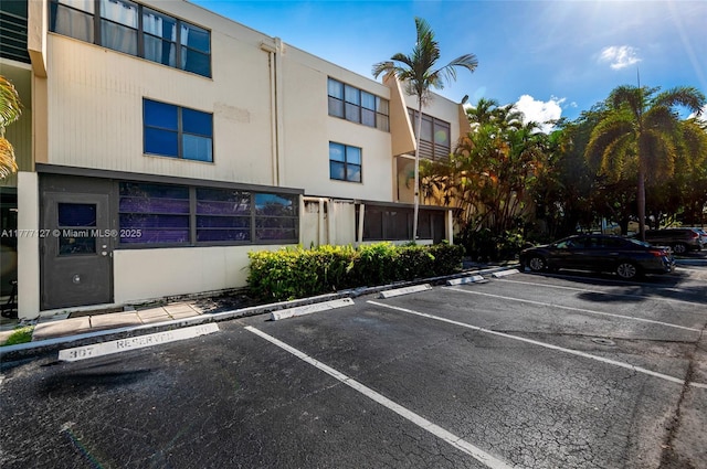 view of property featuring uncovered parking