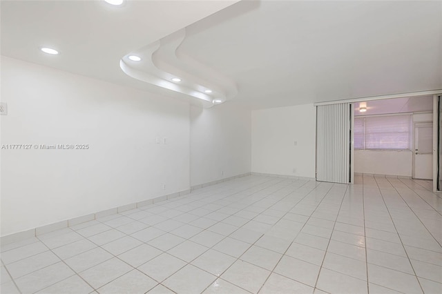 unfurnished room featuring recessed lighting and light tile patterned flooring