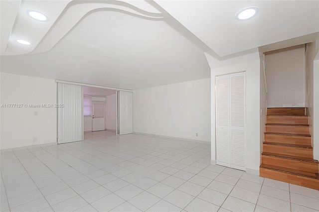 interior space featuring recessed lighting, light tile patterned flooring, and stairway
