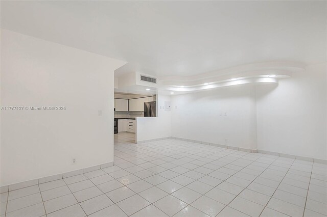 empty room with visible vents and light tile patterned floors