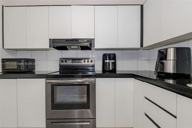 kitchen featuring decorative backsplash, black microwave, white cabinets, electric stove, and under cabinet range hood