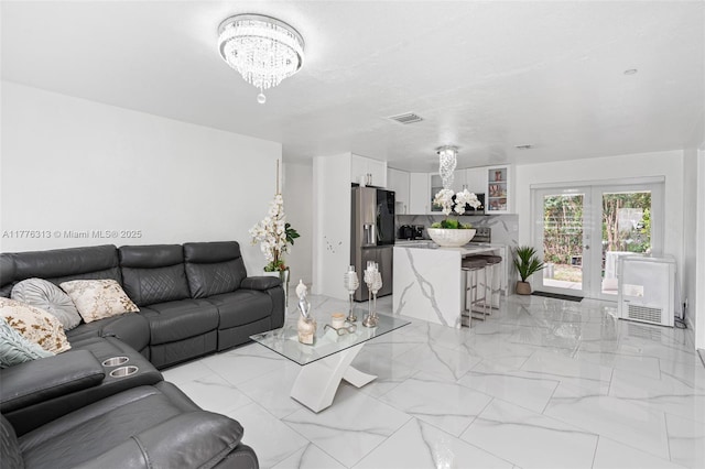 4814 SW 20th St, Fort Lauderdale, FL 33317 - living room with french doors, marble finish floor, a notable chandelier, and visible vents