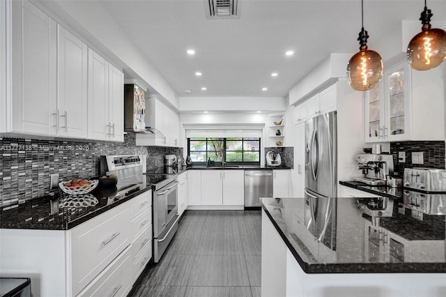 11060 Griffing Blvd, Biscayne Park, FL 33161 - kitchen featuring open shelves, white cabinets, visible vents, appliances with stainless steel finishes, and backsplash