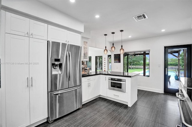11060 Griffing Blvd, Biscayne Park, FL 33161 - kitchen with recessed lighting, dark countertops, white cabinets, visible vents, and stainless steel appliances