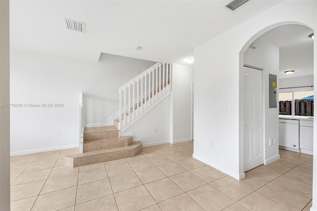 stairway featuring tile patterned flooring, electric panel, and visible vents