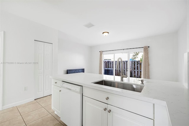 kitchen featuring white cabinets, visible vents, a sink, white dishwasher, and light tile patterned floors